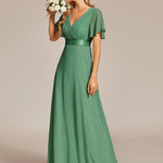 MONICA | Dlouhé šaty pro družičky s empírovým pasem a krátkými volánkovými rukávy | Bridesmaid Dresses | Elora Praha